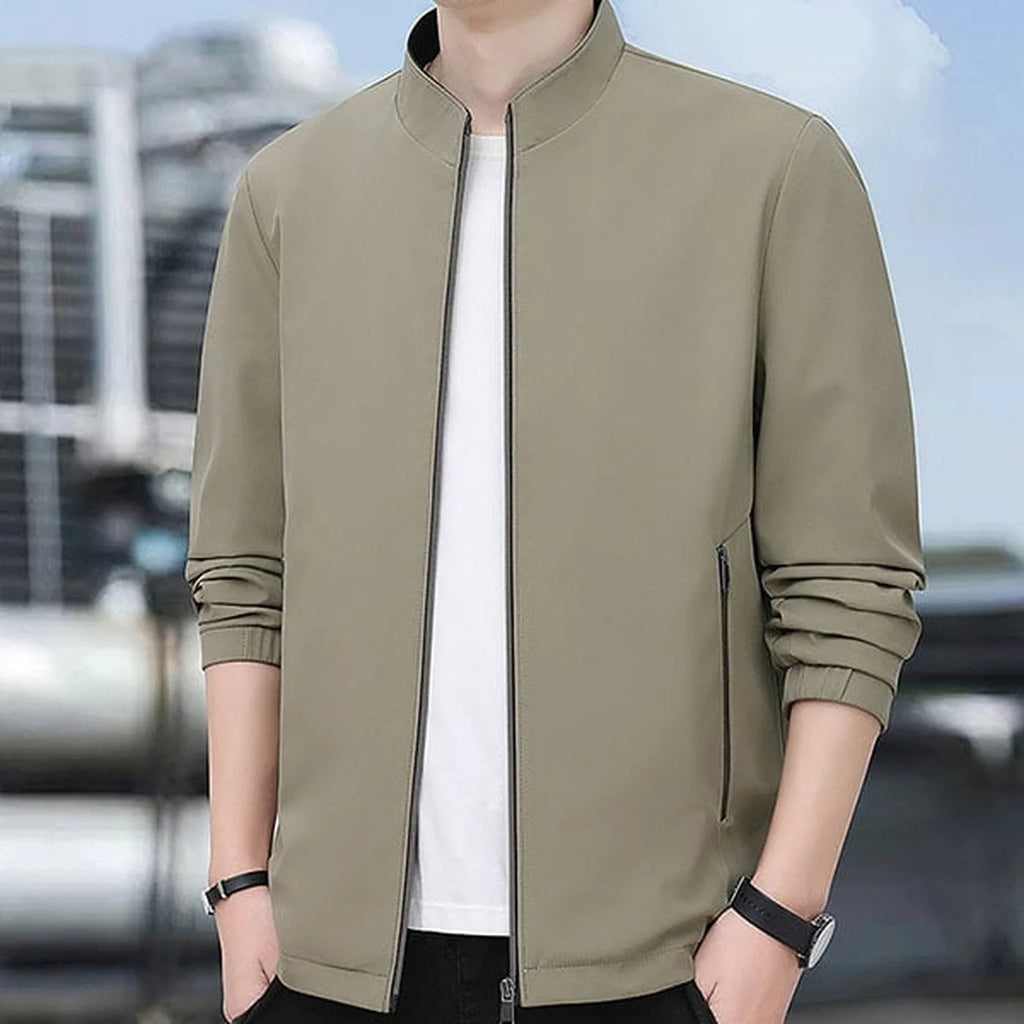 Close-up of the stand collar and open zip worn close to the neck outdoors