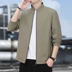 Torso view of the khaki jacket worn open, showing the zipped pocket and straight hem
