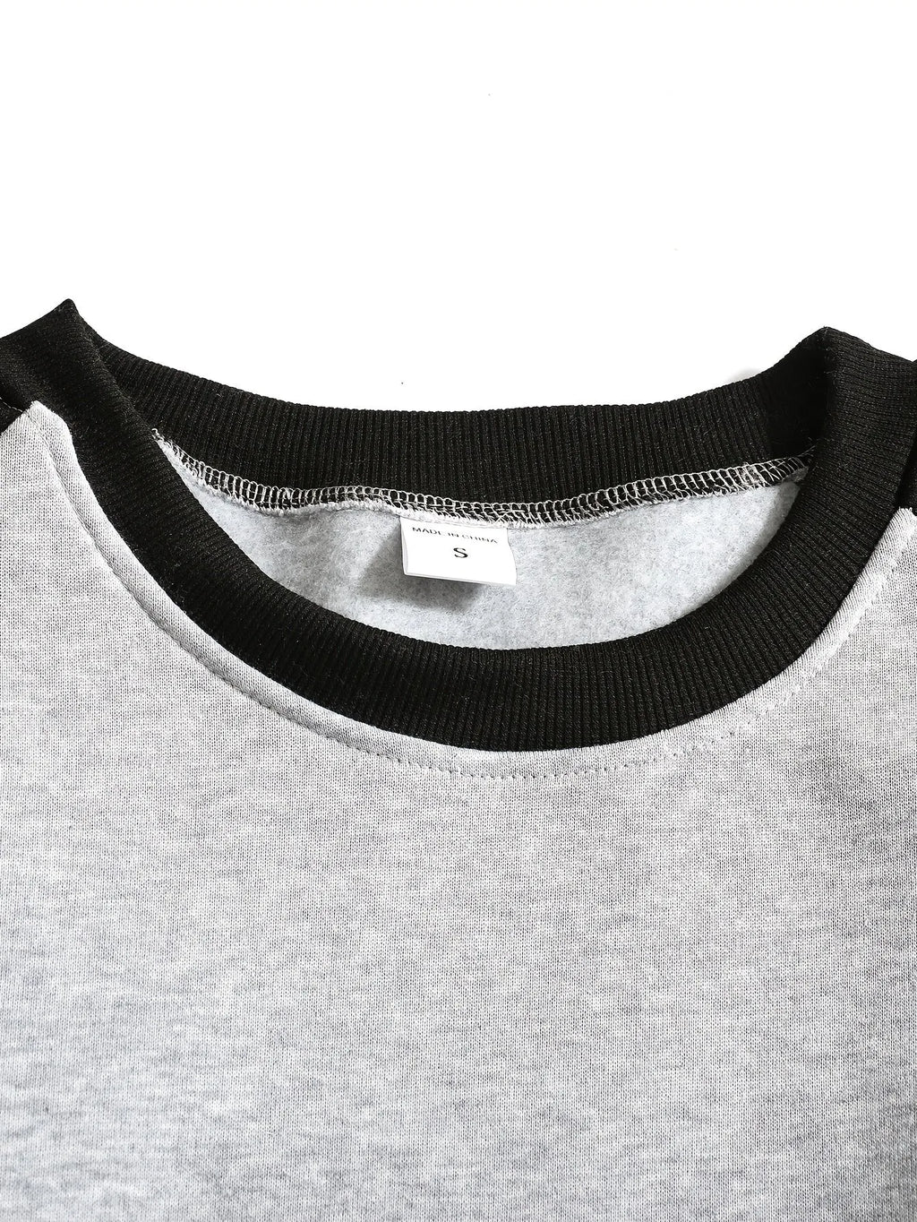 Front view of the raglan sweatshirt showing the crew neckline sitting close to the collarbone