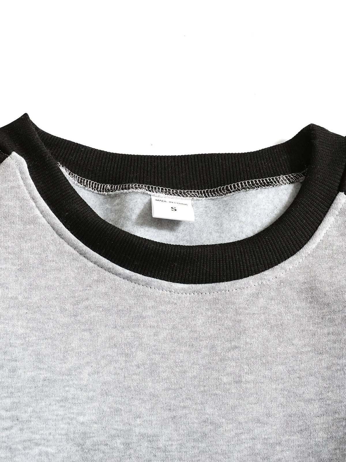 Front view of the raglan sweatshirt showing the crew neckline sitting close to the collarbone