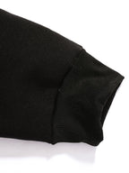 Close-up detail of the raglan sleeve seam running from the collar to the underarm