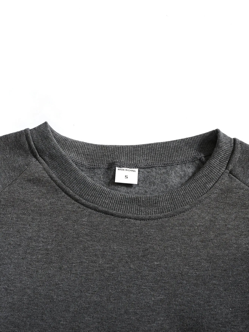 Close-up of the black ribbed cuff folded to show its stretch and thickness
