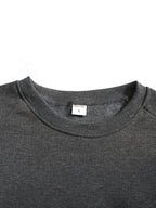 Close-up of the black ribbed cuff folded to show its stretch and thickness