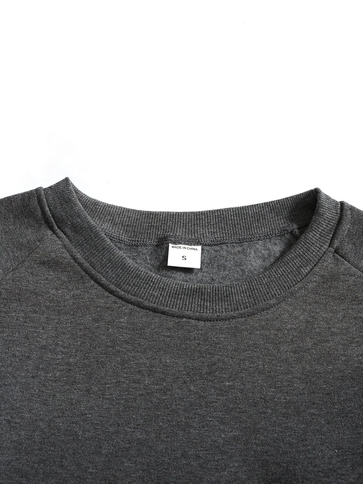 Close-up of the black ribbed cuff folded to show its stretch and thickness