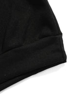 Close-up of the raglan sleeve and shoulder seam in the black colourway