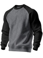 Slightly angled front view showing the two-tone grey and black raglan sweatshirt on a mannequin form