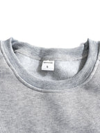 Close-up of the sleeve cuff stitching and ribbed knit texture