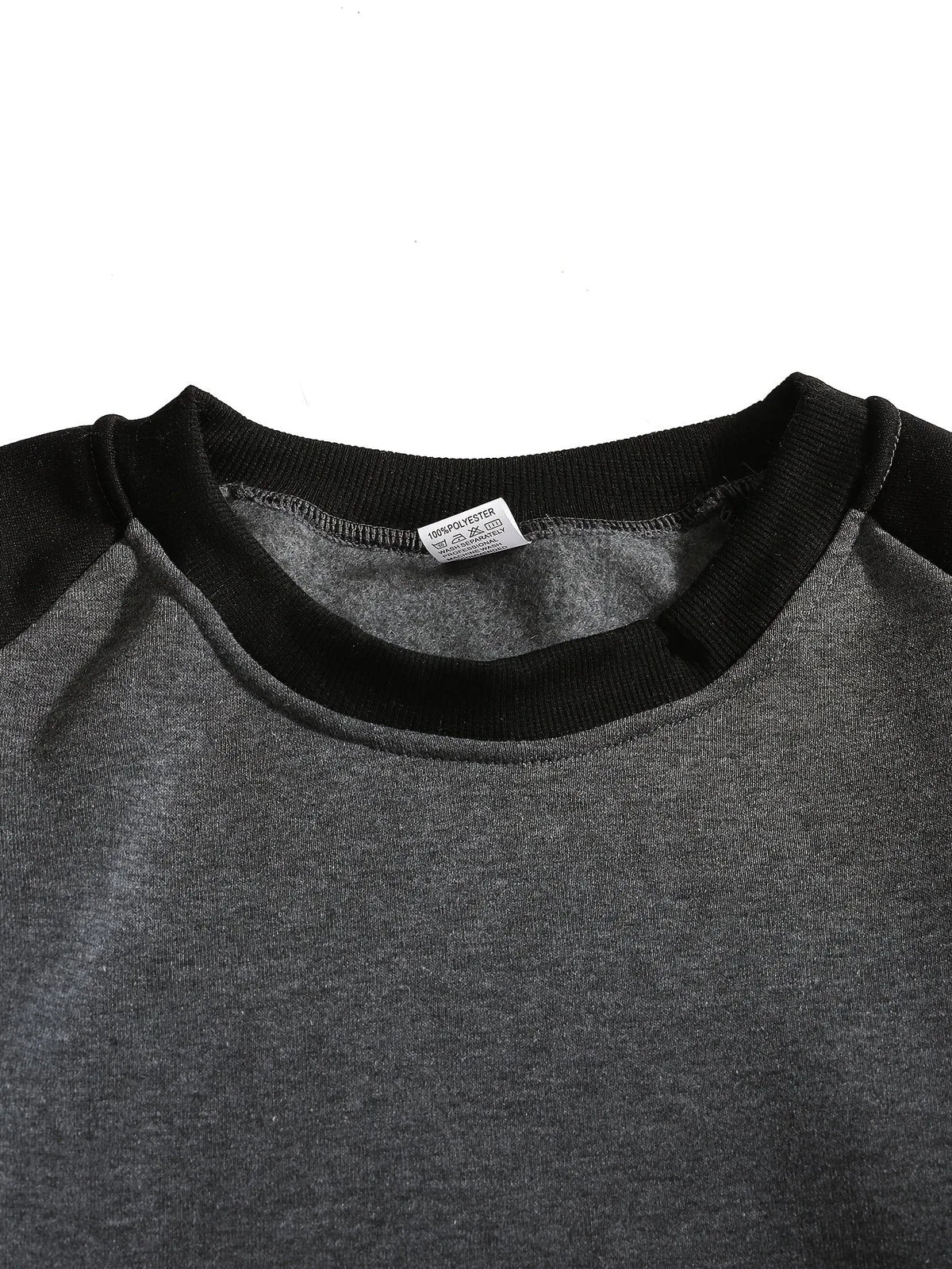 Close-up of the ribbed crew neckline and raglan seam detail in black and grey