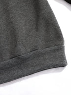 Close-up of the ribbed grey hem showing the fleece fabric texture