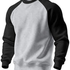 Front view of the sweatshirt in light grey marl with black raglan sleeves and collar