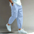 Pale blue cargo trousers with drawstring waist and roomy cargo pocket, relaxed tapered fit shown from the side