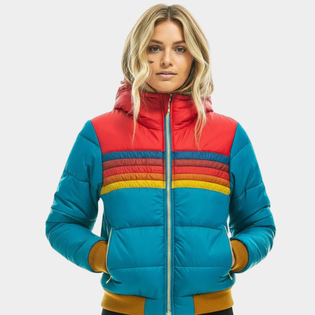 Front view of turquoise hooded puffer jacket with red yoke, rainbow chest stripes and mustard ribbed cuffs