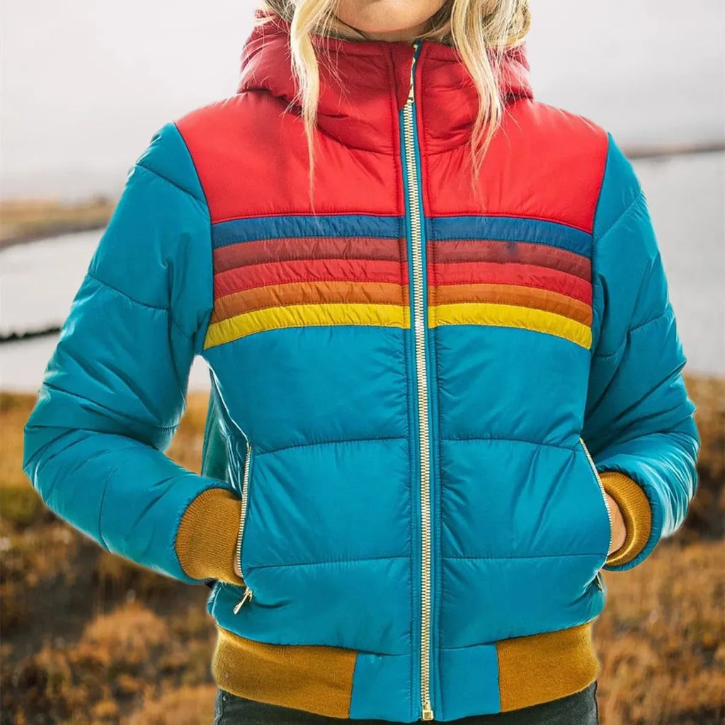 Close-up of turquoise puffer jacket showing the red hood, striped chest band and zipped hand pockets