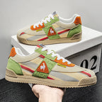 Pair of trainers in off-white and black colourway with striped panels and grooved sole