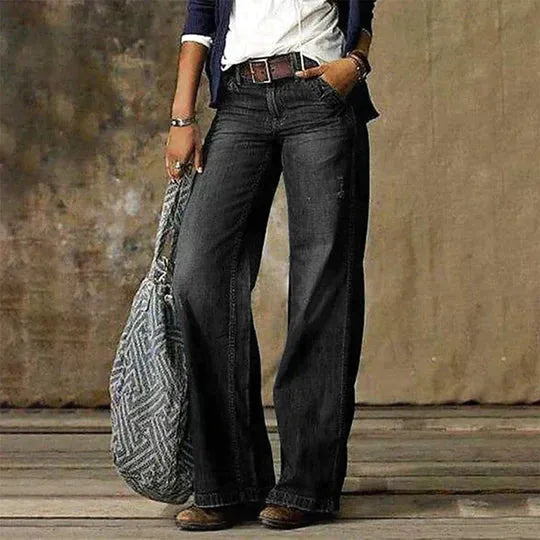 Black wash wide-leg denim jeans styled with a brown belt and layered casual outfit