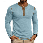 Man wearing a light blue ribbed henley jumper with brown contrast trim and button placket, front view