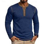 Model wearing the light blue ribbed henley shirt with wristwatch visible, hands in pockets