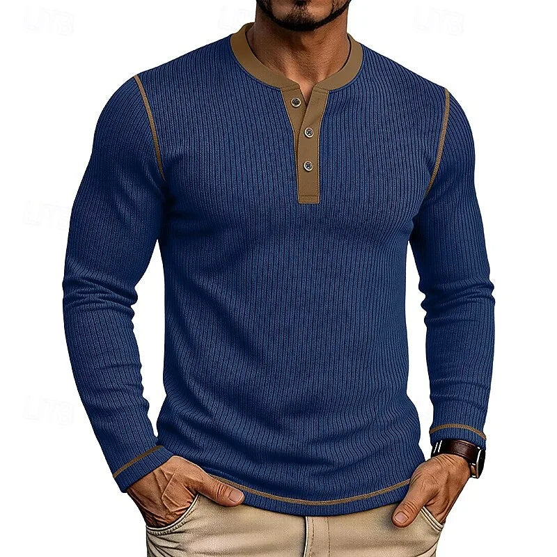 Model wearing the light blue ribbed henley shirt with wristwatch visible, hands in pockets