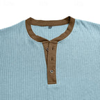 Close-up of the brown contrast collar and button placket on the light blue ribbed henley shirt