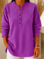Front view of a ribbed Henley tunic top paired with white trousers, showing the relaxed, longline fit