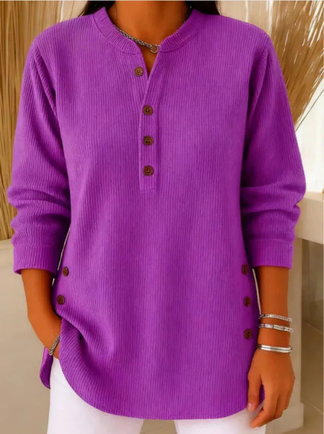 Front view of a ribbed Henley tunic top paired with white trousers, showing the relaxed, longline fit