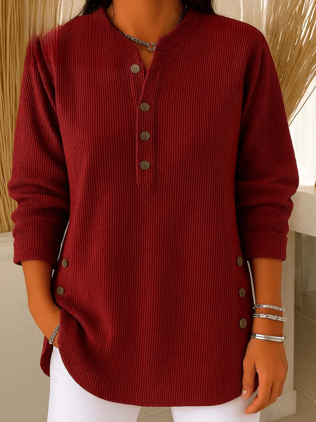 Burgundy ribbed tunic shown from the front, highlighting the stand collar and button detail at the neckline