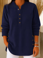 Navy blue ribbed Henley tunic top with long sleeves and visible side button trim near the hem