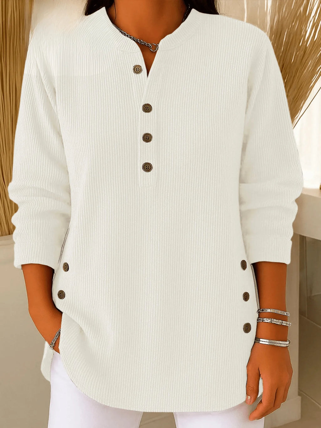 White ribbed Henley tunic top with button front, styled with white trousers for a clean look