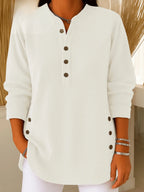 White ribbed Henley tunic top with button front, styled with white trousers for a clean look