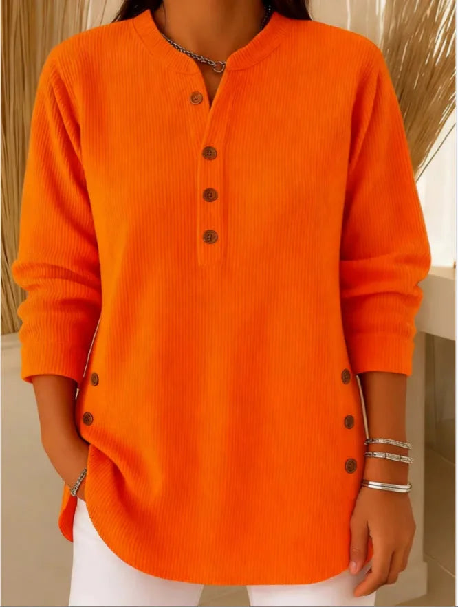 Orange ribbed tunic top on a hanger-free model shot, showing the full longline silhouette and curved hem