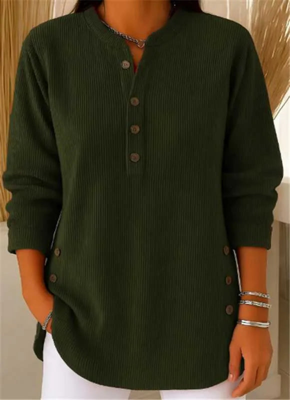 Side angle of a ribbed tunic top showing the decorative buttons along the seam near the curved hem