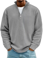Front-facing view of a ribbed knit jumper highlighting the relaxed drop-shoulder fit and half-zip neckline