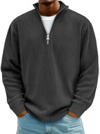 Charcoal grey ribbed quarter-zip jumper worn over a white tee, showing the relaxed long-sleeve fit