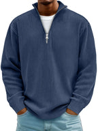 Navy blue ribbed quarter-zip jumper showing the stand-up collar and ribbed cuff detail on the sleeve