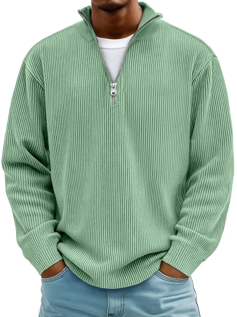 Sage green ribbed quarter-zip jumper with open collar, worn casually with light wash jeans