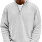Light grey ribbed quarter-zip jumper on model, front view with half-zip collar open at the neck