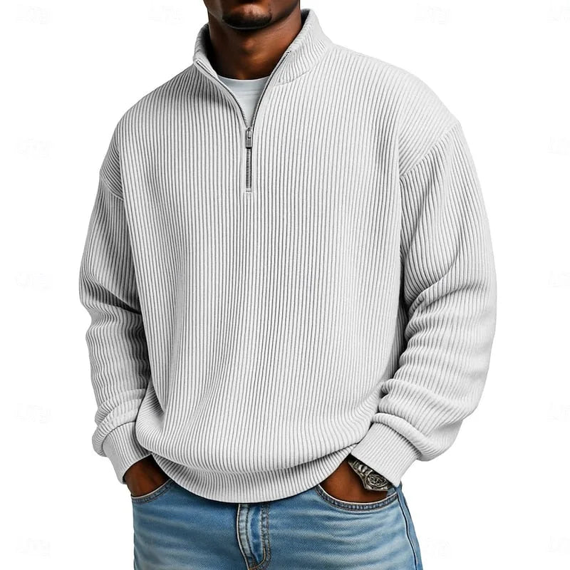 Model with hands in jeans pockets wearing the sky blue ribbed quarter-zip pullover, front angle