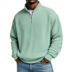 Close-up front view of the sage green ribbed quarter-zip jumper showing the stand collar and half-zip fastening