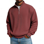 Close-up front view of the wine red ribbed quarter-zip jumper showing the ribbed knit texture