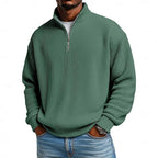 Close-up front view of the deep green ribbed quarter-zip jumper with unzipped collar detail
