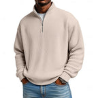 Close-up front view of the beige ribbed quarter-zip jumper worn with a white undershirt