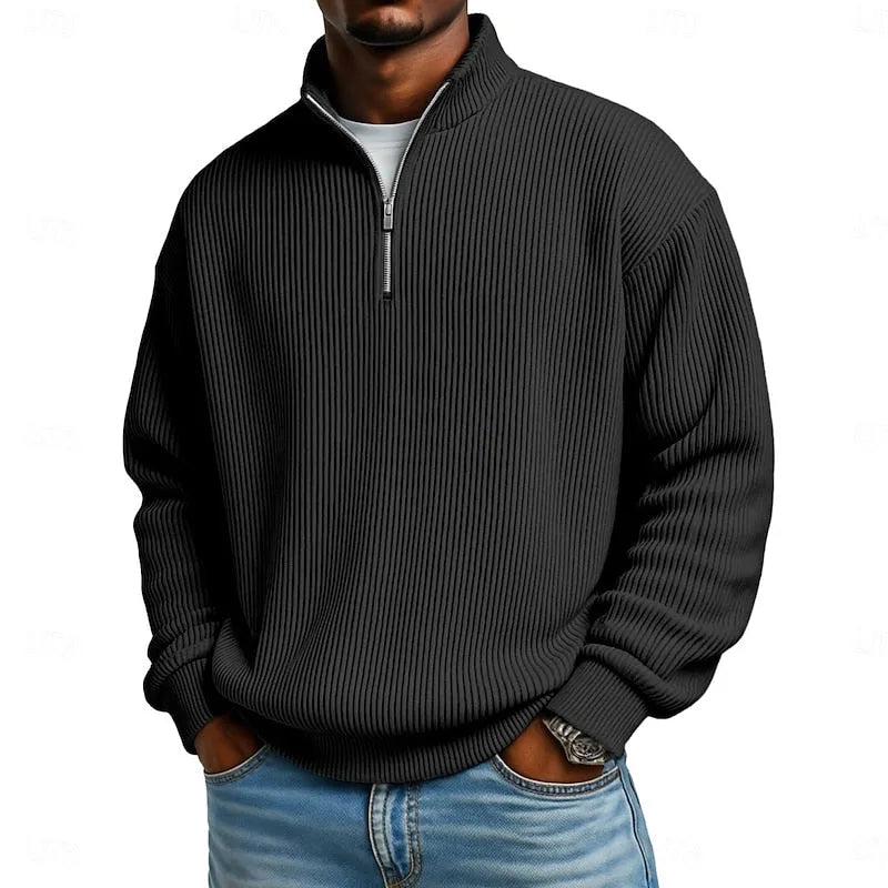 Close-up front view of the black ribbed quarter-zip jumper showing the zip and rib knit pattern