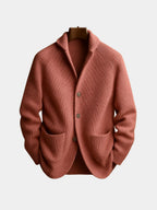 Front view of a pink ribbed knit cardigan with notch collar, three buttons and patch pockets, shown on a hanger