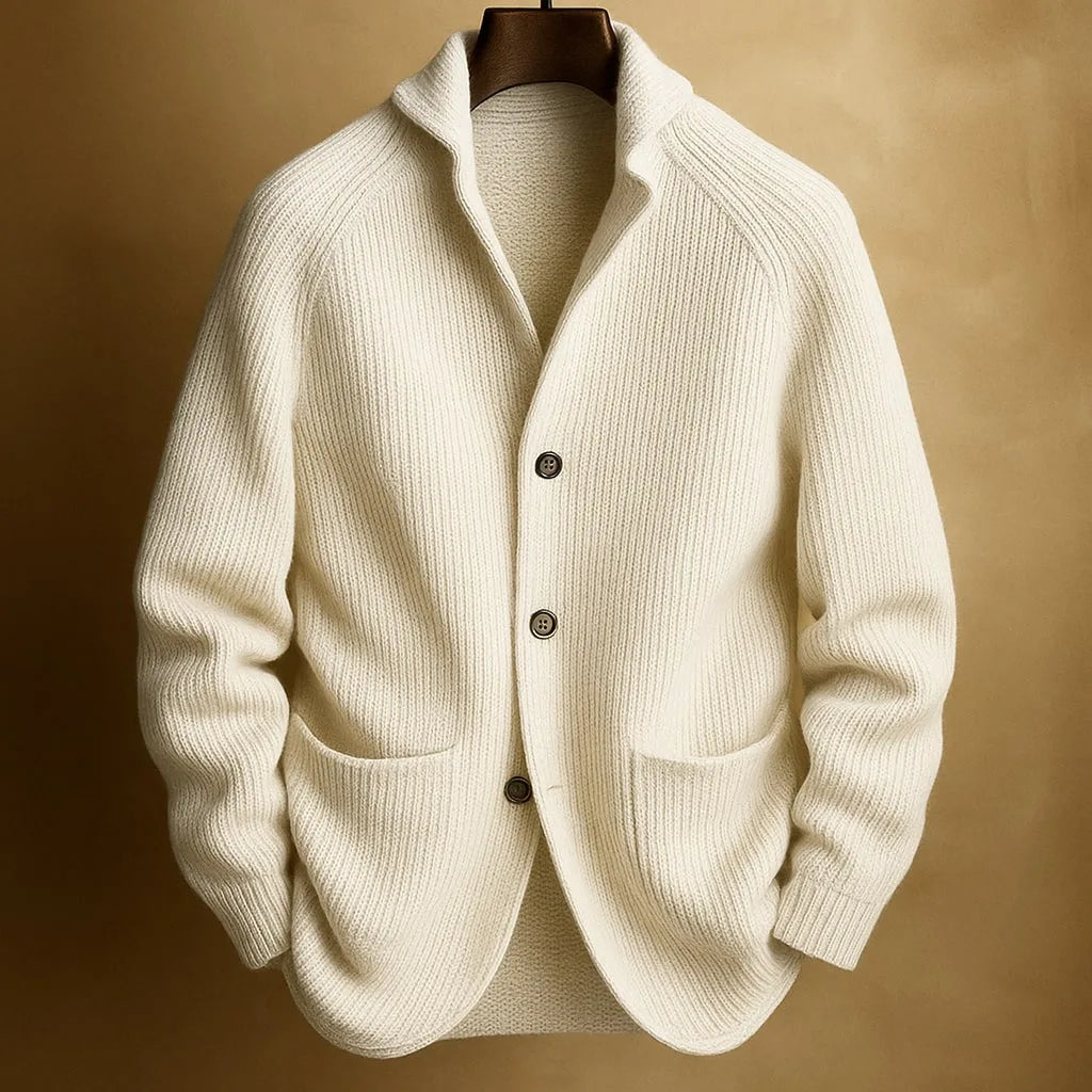 Cream white ribbed knit cardigan with notch collar and dark buttons, hanging against a soft tan background