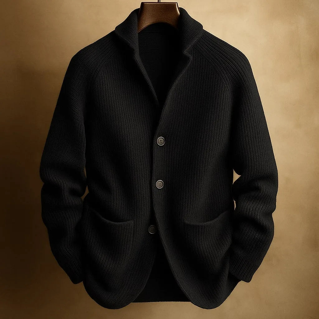 Black ribbed knit cardigan with notch collar and patch pockets, displayed on a wooden hanger