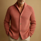 Close-up of a man wearing the pink ribbed cardigan, showing the shawl-style collar and button detail