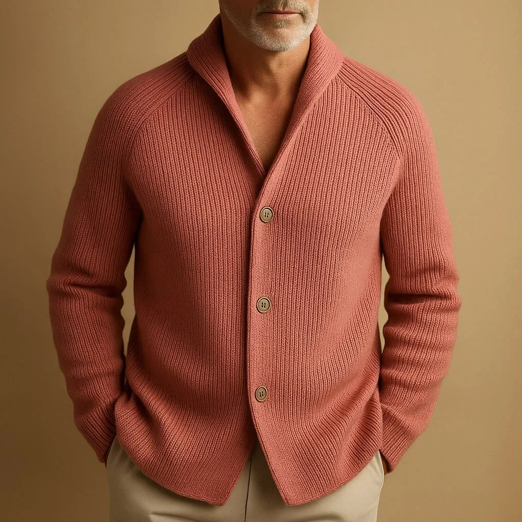 Close-up of a man wearing the pink ribbed cardigan, showing the shawl-style collar and button detail