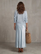 Detail shot of the ribbed knit cuff and sleeve of the V-neck jumper