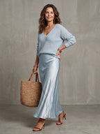 Full length front view highlighting the relaxed fit of the knit jumper over the fluid satin skirt