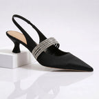 Front angle of champagne kitten heels highlighting slingback strap and sculpted heel shape